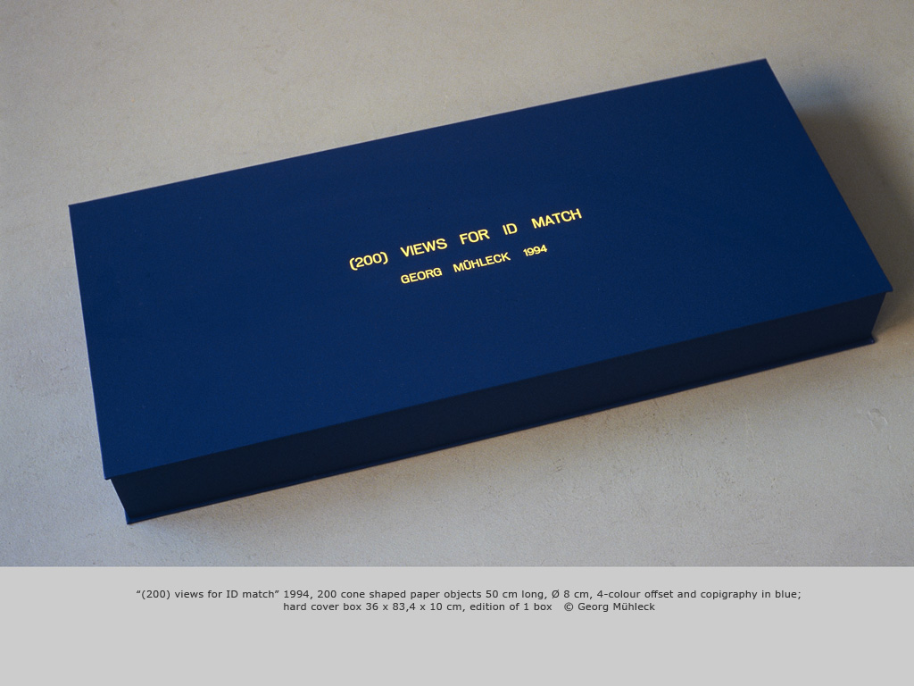“(200) views for ID match” 1994, 200 cone shaped paper objects 50 cm long, Ø 8 cm, 4-colour offset and copigraphy in blue; hard cover box 36 x 83,4 x 10 cm, edition of 1 box   © Georg Mühleck